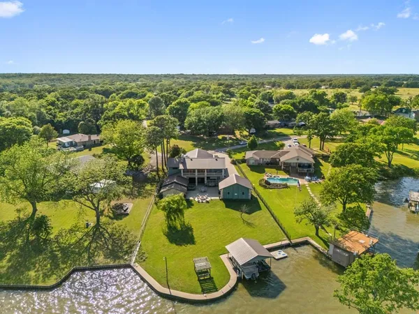 an aerial view of a residential houses with outdoor space