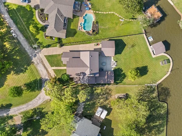 an aerial view of residential house with outdoor space and swimming pool