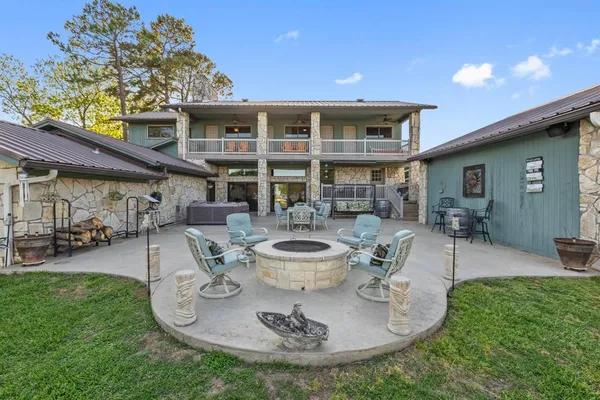 a view of a house with backyard and sitting area