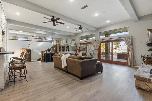 a living room with furniture and wooden floor