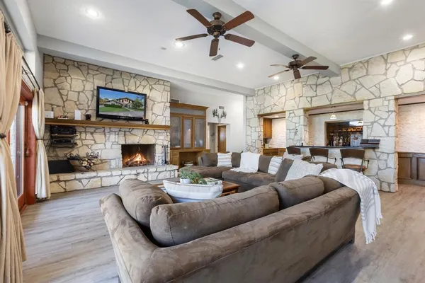 a living room with furniture a fireplace and a flat screen tv