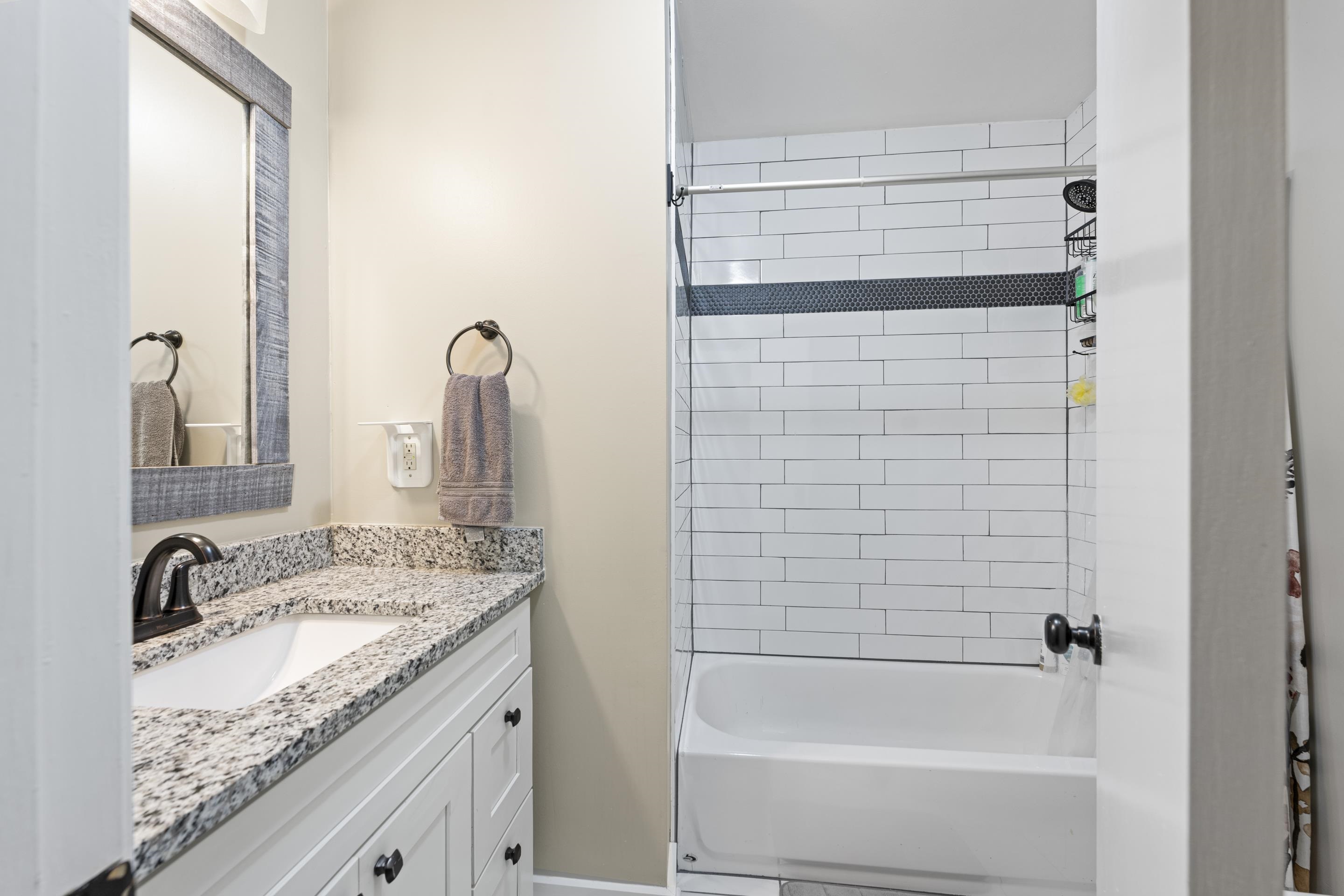 260 South Fenwick Road Memphis, TN 38111 - Photo 31 of 40 Single vanity with granite and Tub/shower with subway tile and accents.