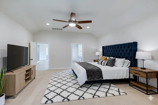 a bedroom with a bed and a flat screen tv