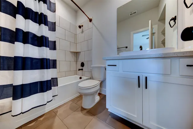 a bathroom with a toilet a sink and a mirror