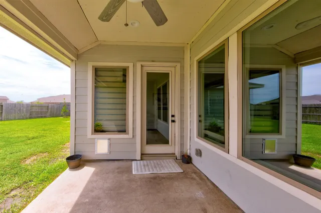 a view of a patio with table and chairs and potted plants