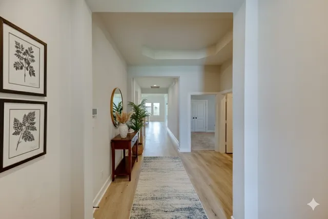 a hallway with a view of living room