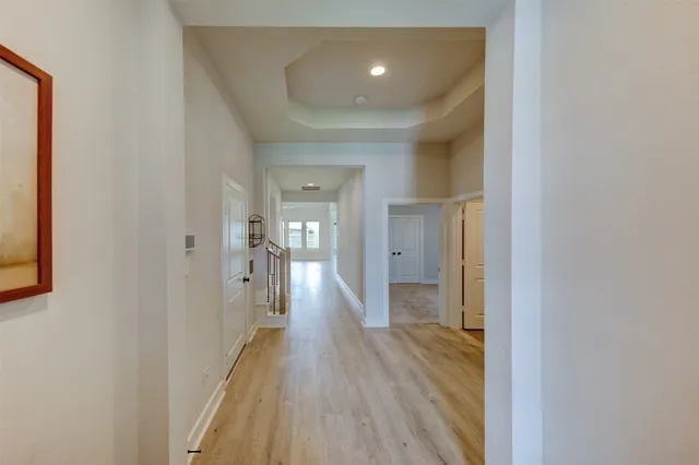a view of a hallway with wooden floor