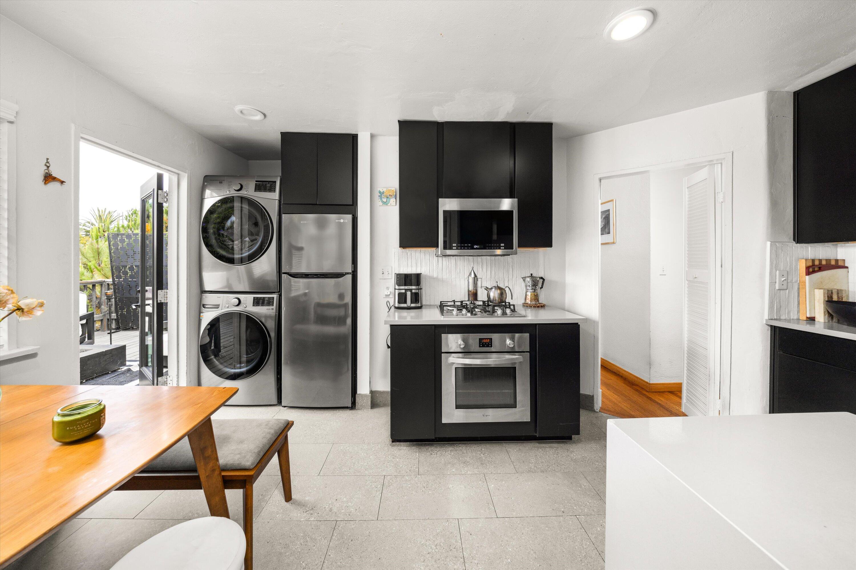 424 East Arrellaga Street Santa Barbara, CA 93101 - Photo 12 of 32 a living room with stainless steel appliances furniture a fireplace a flat screen tv and a view of kitchen