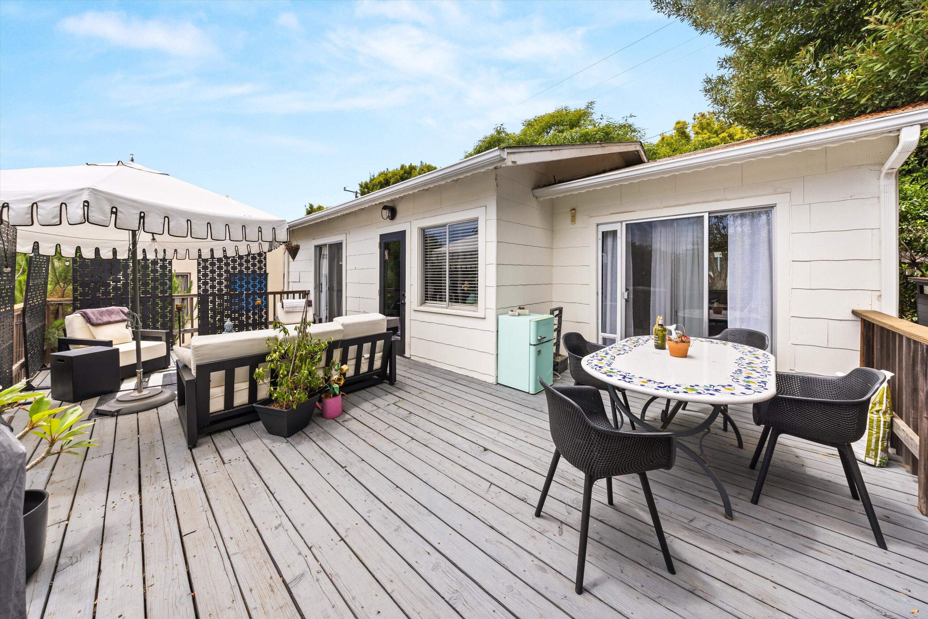 424 East Arrellaga Street Santa Barbara, CA 93101 - Photo 22 of 32 a view of a patio with table and chairs with wooden floor and fence