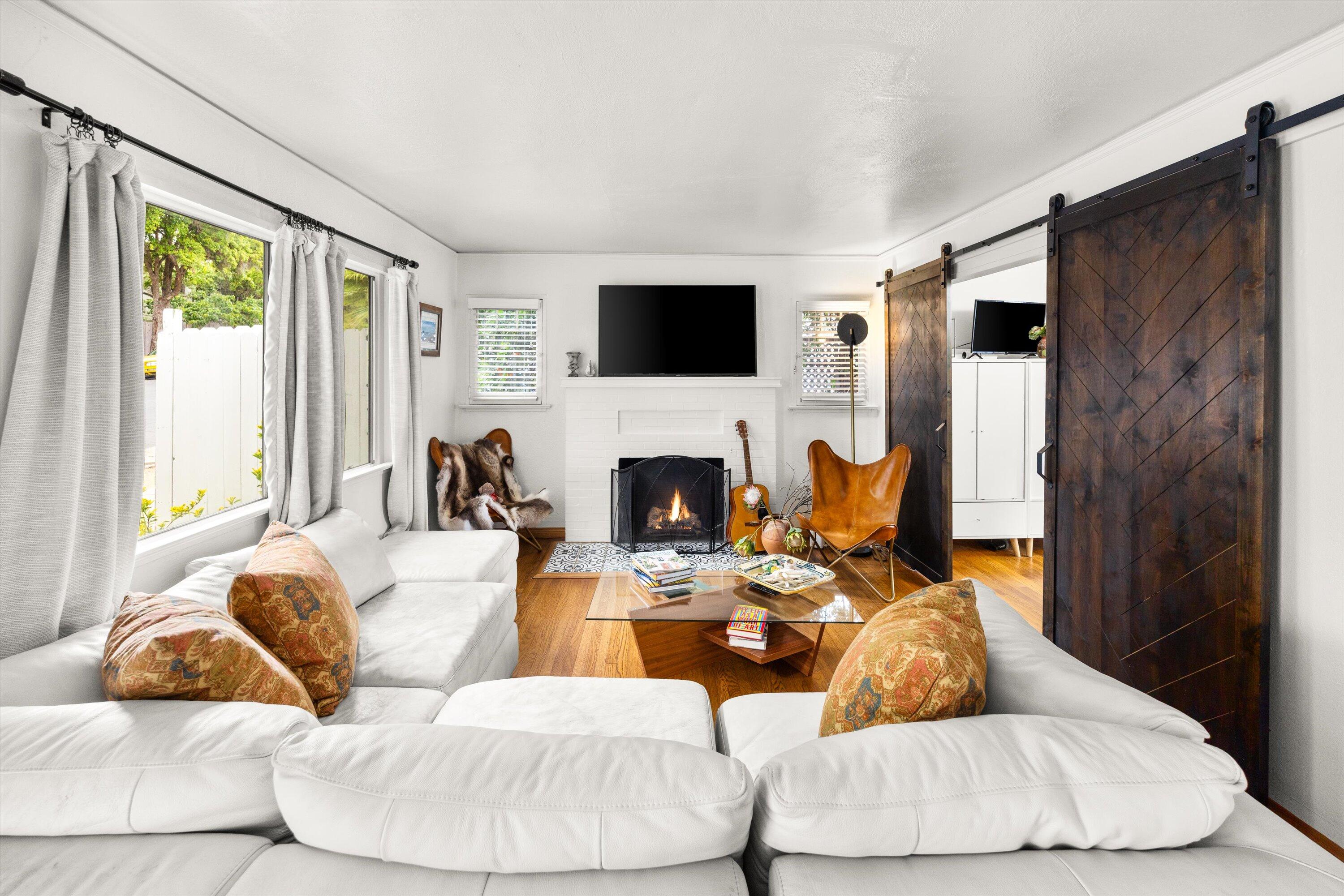 424 East Arrellaga Street Santa Barbara, CA 93101 - Photo 6 of 32 a living room with furniture fireplace and a flat screen tv