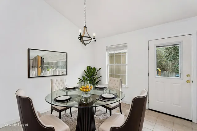 a view of a dining room with furniture and window