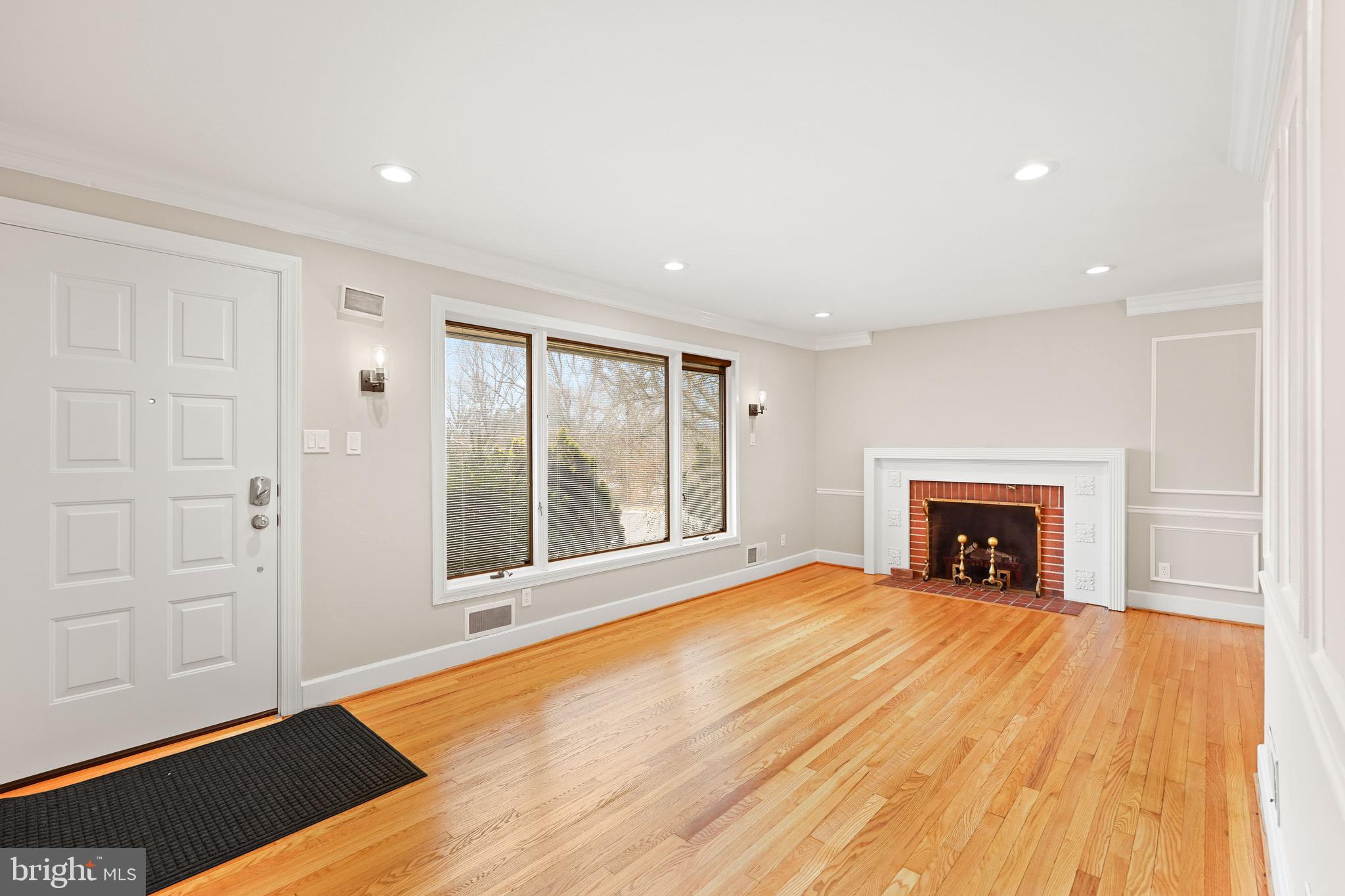 1600 Oaklawn Court Silver Spring, MD 20903 - Photo 11 of 62 a view of an empty room with a fireplace and a window