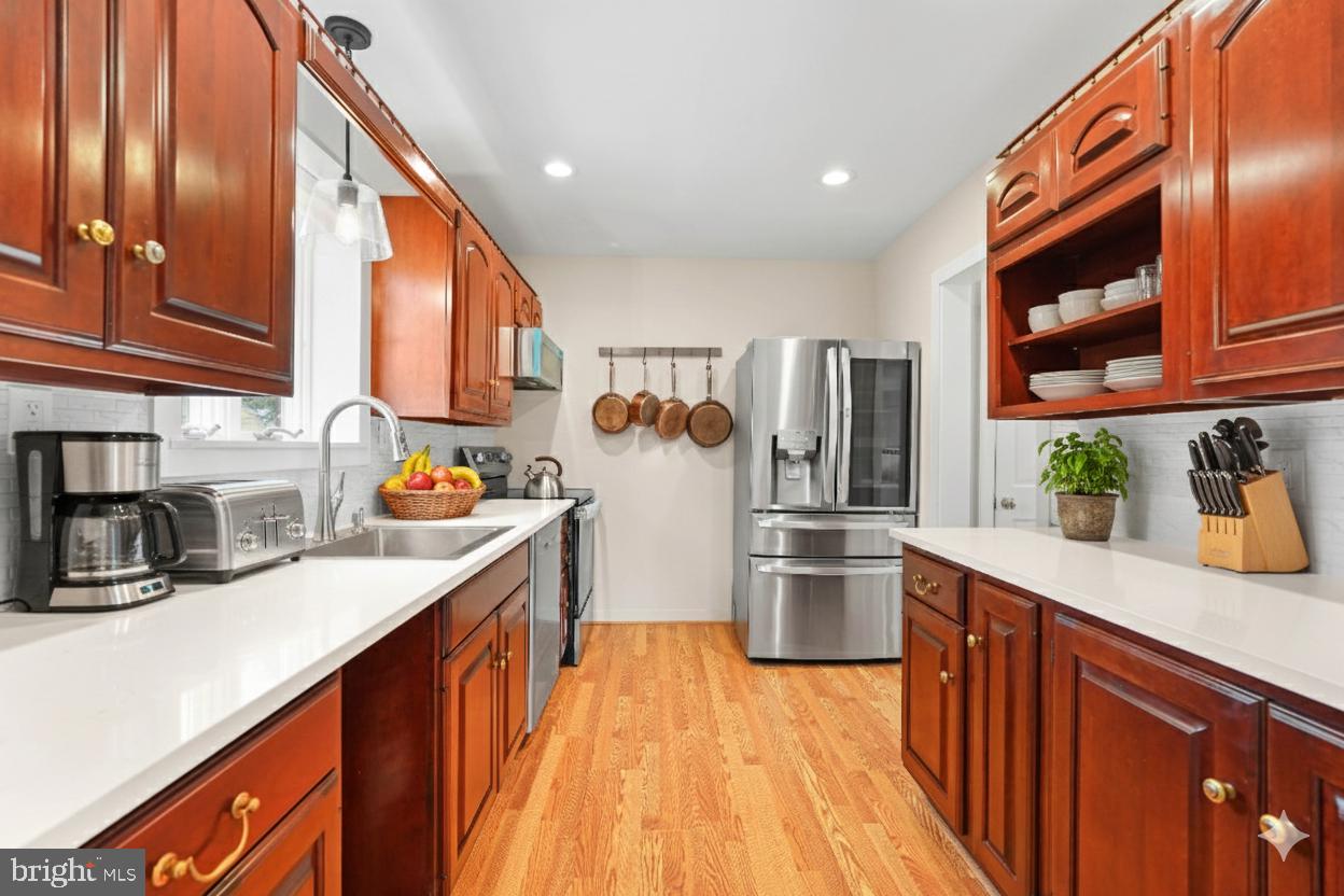1600 Oaklawn Court Silver Spring, MD 20903 - Photo 21 of 62 a kitchen with stainless steel appliances granite countertop a sink and cabinets
