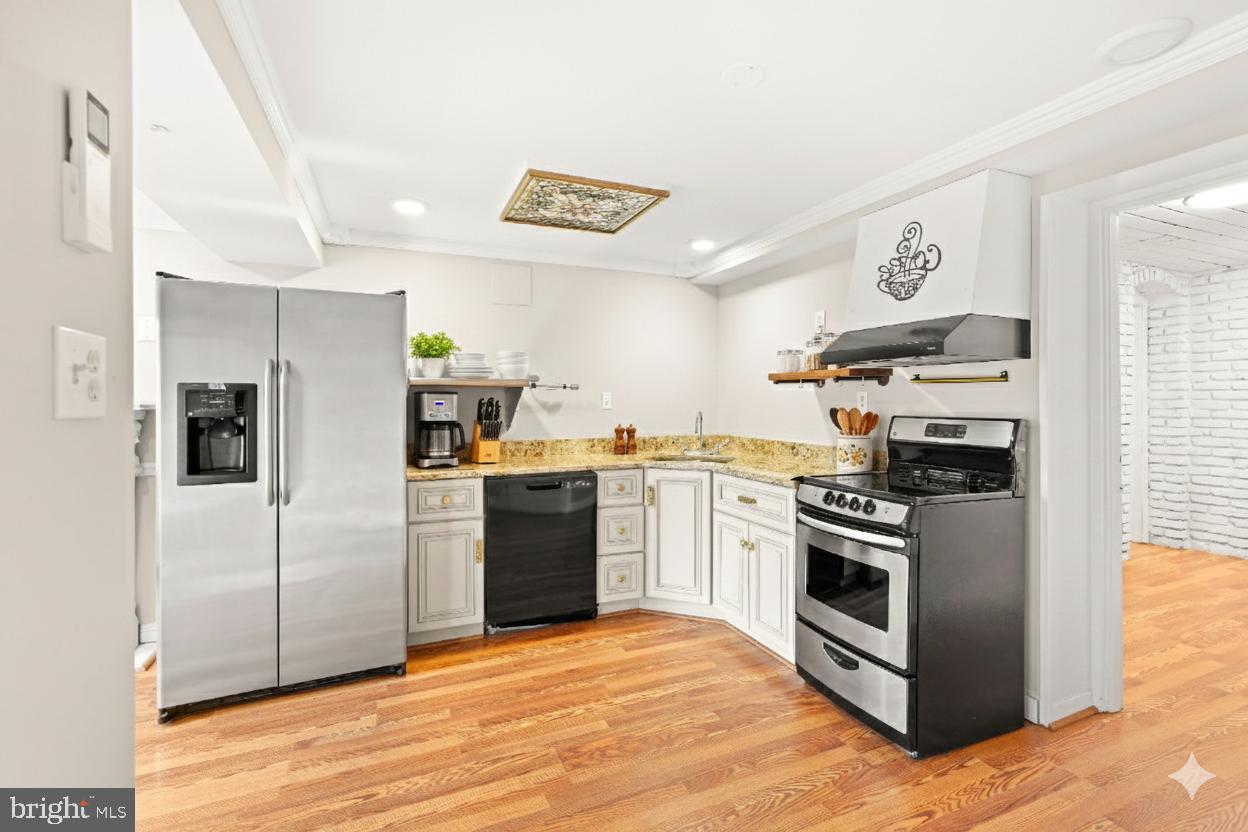 1600 Oaklawn Court Silver Spring, MD 20903 - Photo 49 of 62 a kitchen with stainless steel appliances granite countertop a refrigerator and a stove