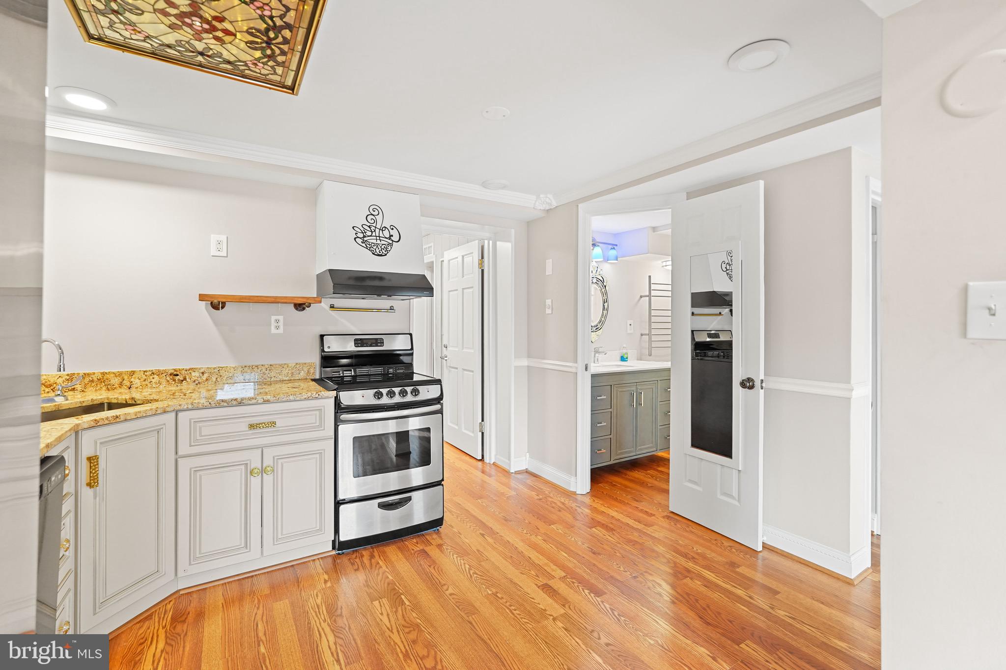 1600 Oaklawn Court Silver Spring, MD 20903 - Photo 50 of 62 a kitchen with stainless steel appliances a stove a sink and a refrigerator