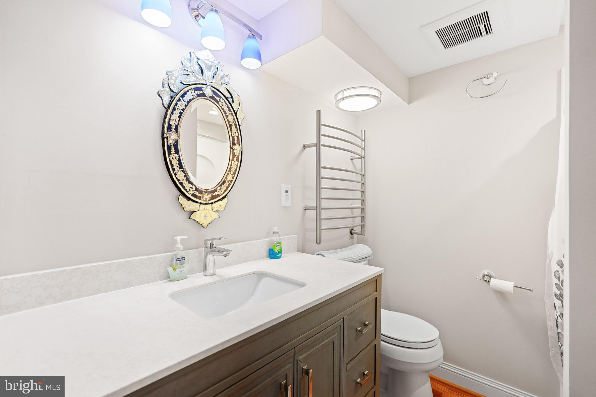 1600 Oaklawn Court Silver Spring, MD 20903 - Photo 51 of 62 a bathroom with a toilet a sink and a mirror