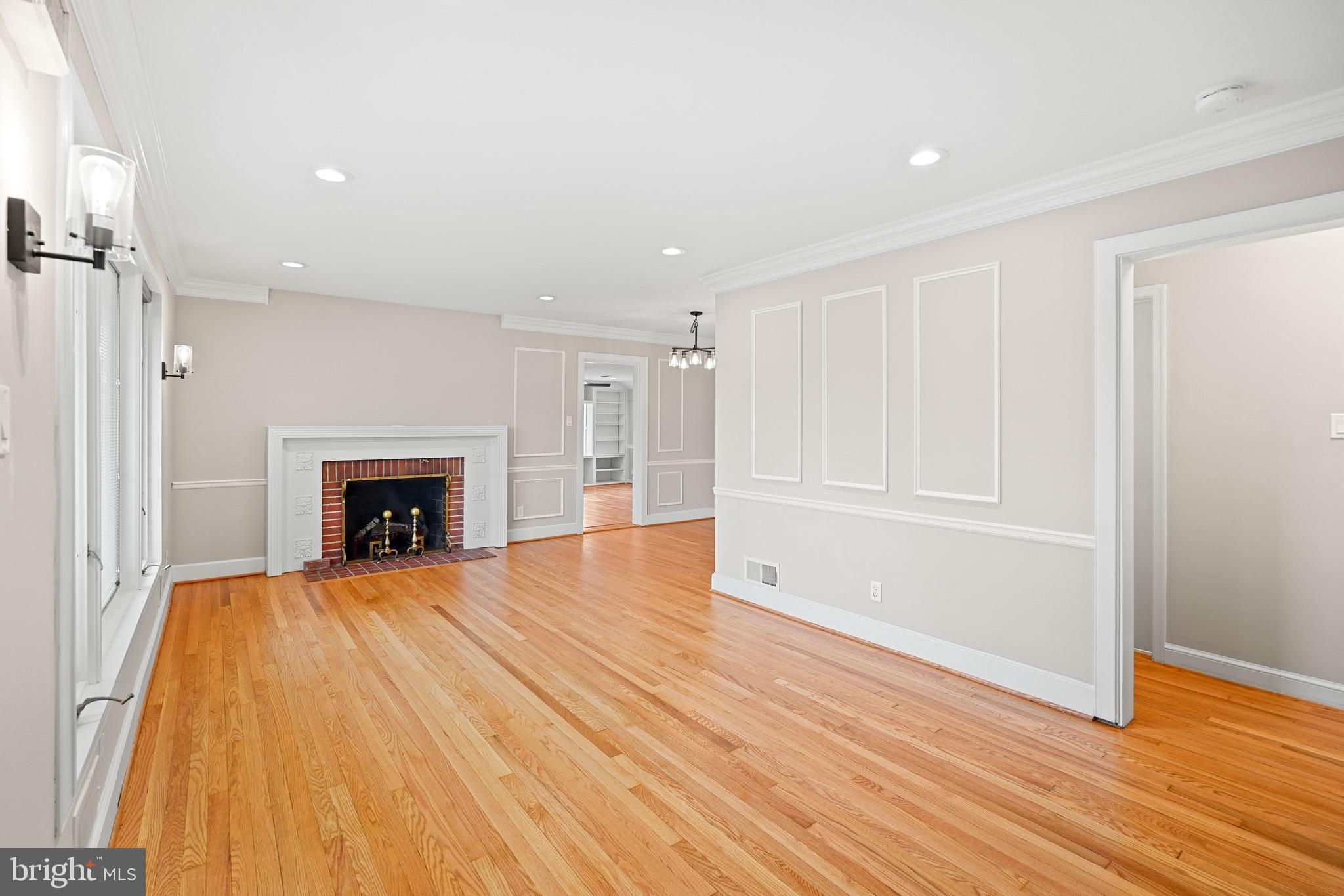 1600 Oaklawn Court Silver Spring, MD 20903 - Photo 10 of 62 a view of an empty room with wooden floor fireplace and a window