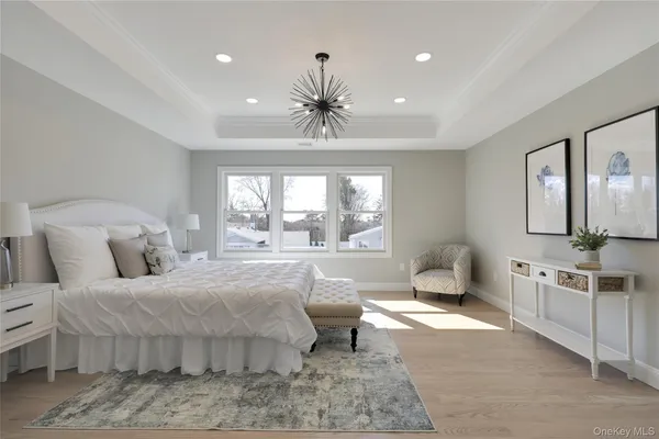 a bedroom with a large bed and ceiling fan