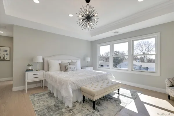 a bedroom with furniture and a large window