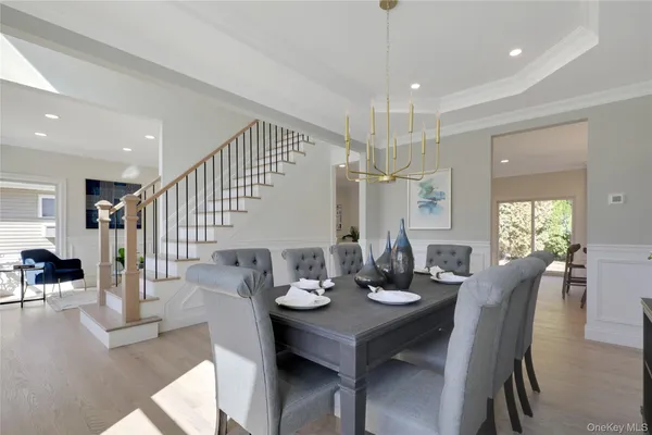 a view of a a dining room with furniture window and wooden floor