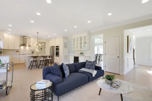 a living room with furniture kitchen and a table