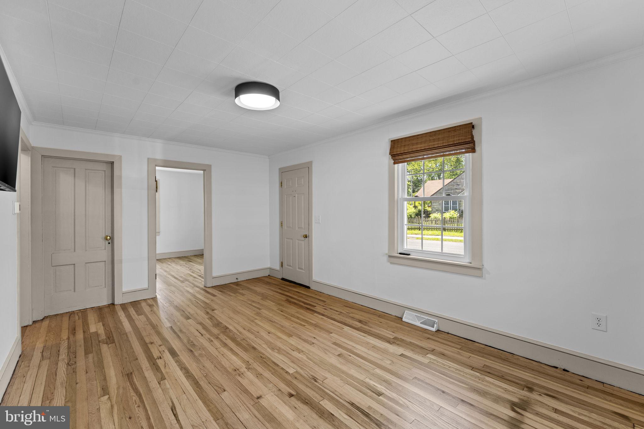 216 Walnut Street Berryville, VA 22611 - Photo 9 of 36 a view of an empty room with window and wooden floor