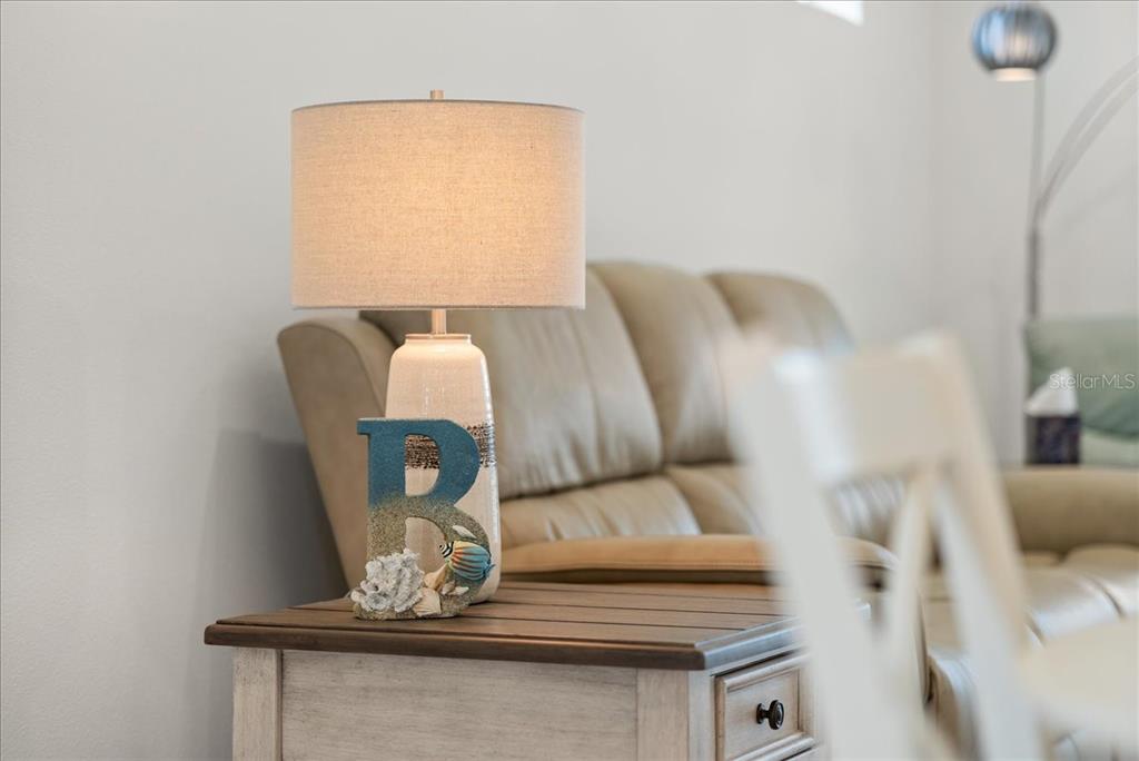 9434 Ballaster Pointe Loop Palmetto, FL 34221 - Photo 19 of 66 a living room with furniture and a table