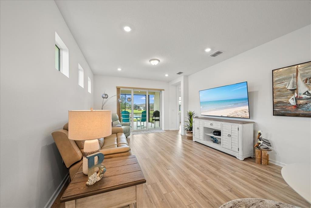 9434 Ballaster Pointe Loop Palmetto, FL 34221 - Photo 20 of 66 a living room with furniture and a flat screen tv