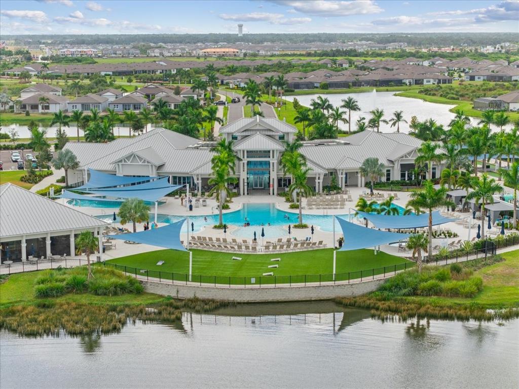 9434 Ballaster Pointe Loop Palmetto, FL 34221 - Photo 2 of 66 a aerial view of a house with a garden and lake view