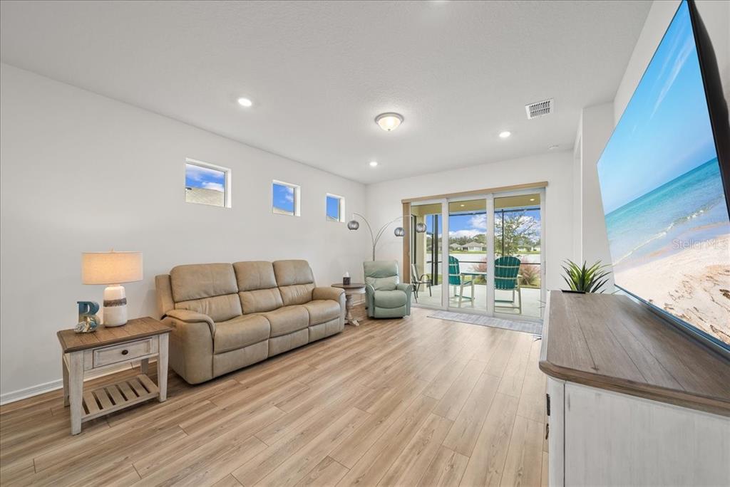 9434 Ballaster Pointe Loop Palmetto, FL 34221 - Photo 21 of 66 a living room with furniture and a large window