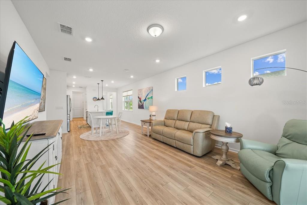9434 Ballaster Pointe Loop Palmetto, FL 34221 - Photo 22 of 66 a living room with furniture and a flat screen tv