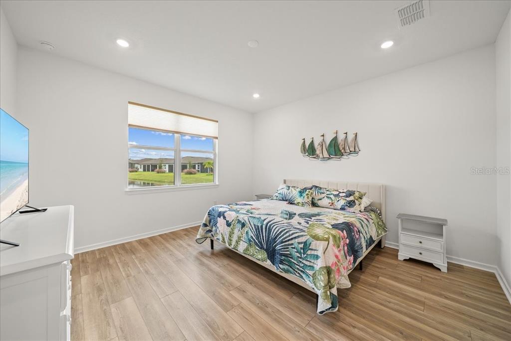 9434 Ballaster Pointe Loop Palmetto, FL 34221 - Photo 24 of 66 a bed sitting in a bedroom next to a window