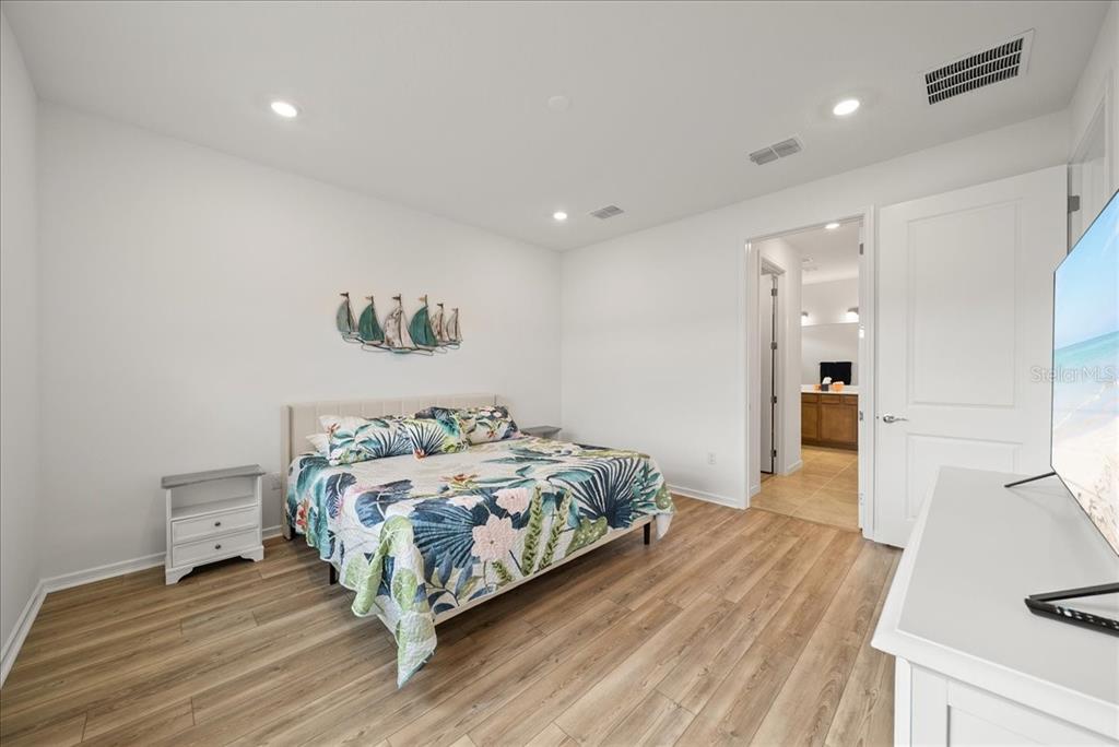 9434 Ballaster Pointe Loop Palmetto, FL 34221 - Photo 27 of 66 a bedroom with a bed and a couch