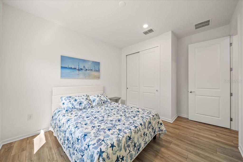 9434 Ballaster Pointe Loop Palmetto, FL 34221 - Photo 30 of 66 a bedroom with a bed and a painting on the wall