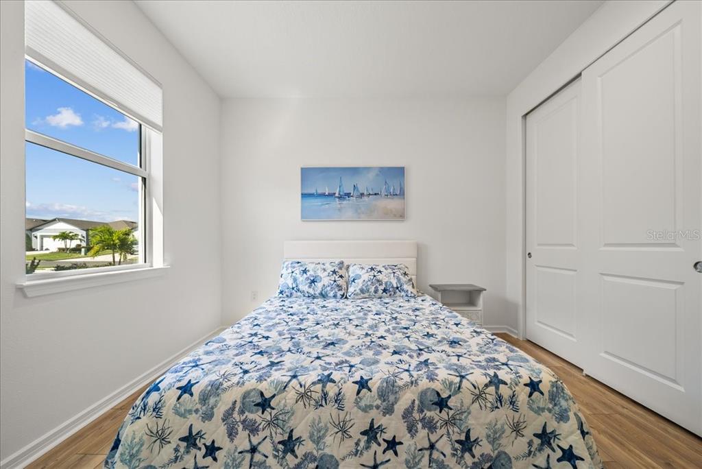 9434 Ballaster Pointe Loop Palmetto, FL 34221 - Photo 31 of 66 a bedroom with a bed and a window