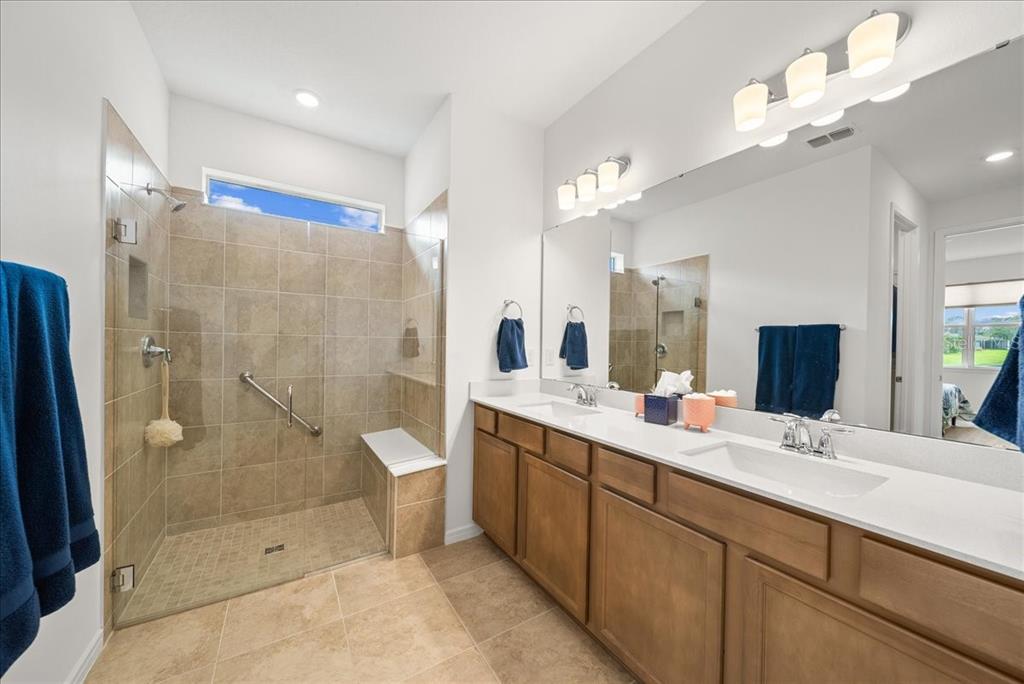 9434 Ballaster Pointe Loop Palmetto, FL 34221 - Photo 34 of 66 a bathroom with a double vanity sink mirror double shower and a mirror