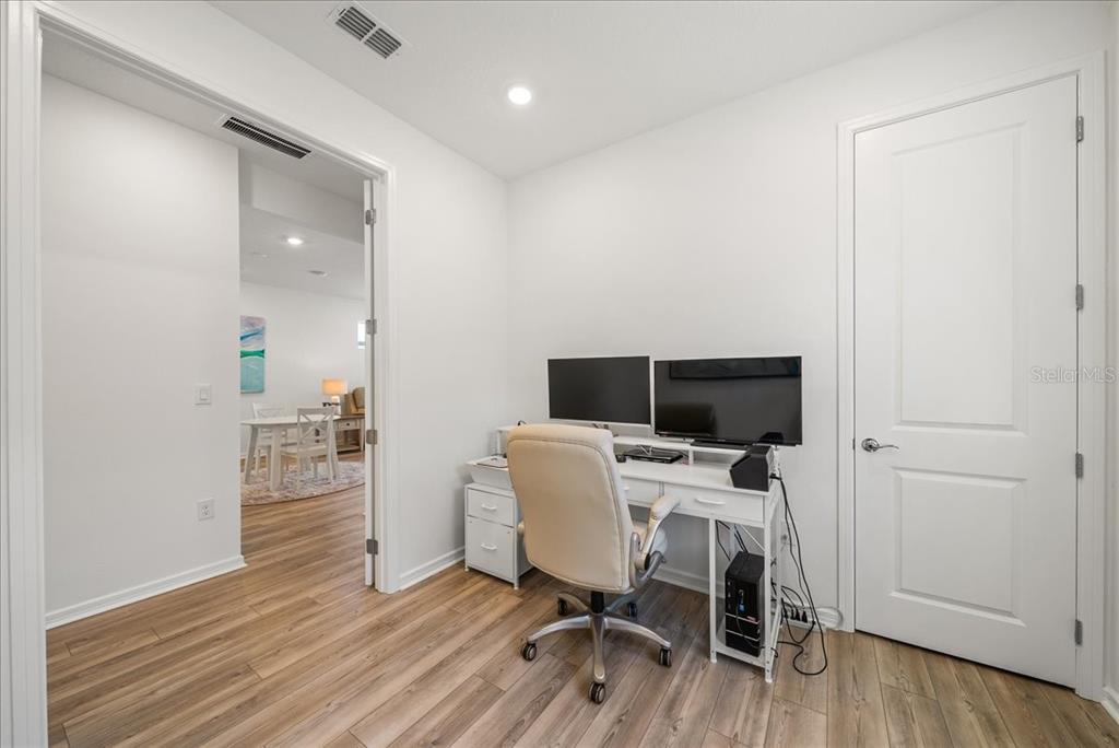 9434 Ballaster Pointe Loop Palmetto, FL 34221 - Photo 36 of 66 a view of a workspace with furniture and wooden floor