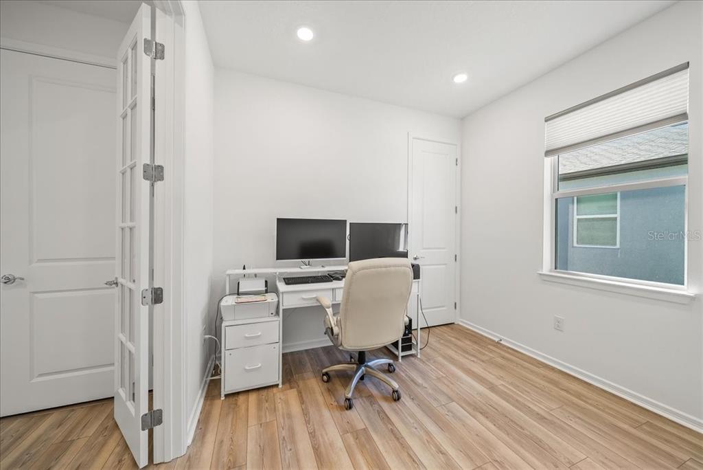 9434 Ballaster Pointe Loop Palmetto, FL 34221 - Photo 37 of 66 a view of a workspace with furniture and wooden floor