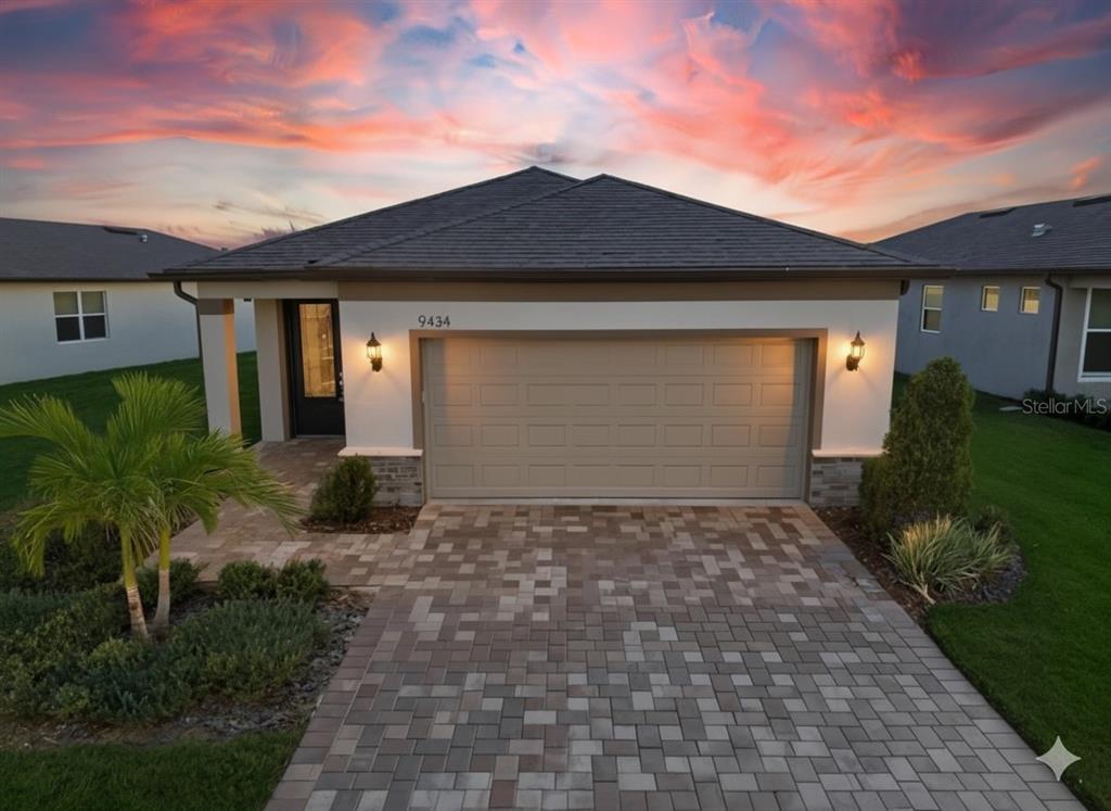 9434 Ballaster Pointe Loop Palmetto, FL 34221 - Photo 44 of 66 a front view of a house with a yard