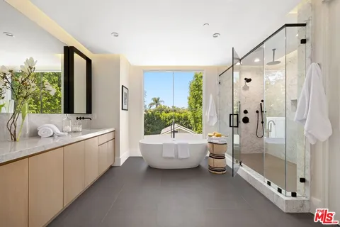 a bathroom with a double vanity sink toilet and shower