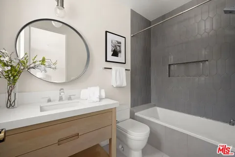 a bath room with a toilet a sink and a bath tub