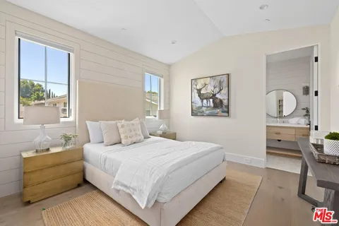 a bedroom with a large bed and a window