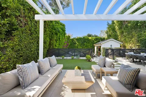 a view of a patio with couches chairs and a yard