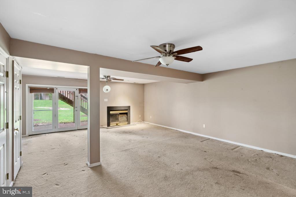 5235 Lightfoot Path Columbia, MD 21044 - Photo 24 of 32 wooden floor in an empty room with a fireplace