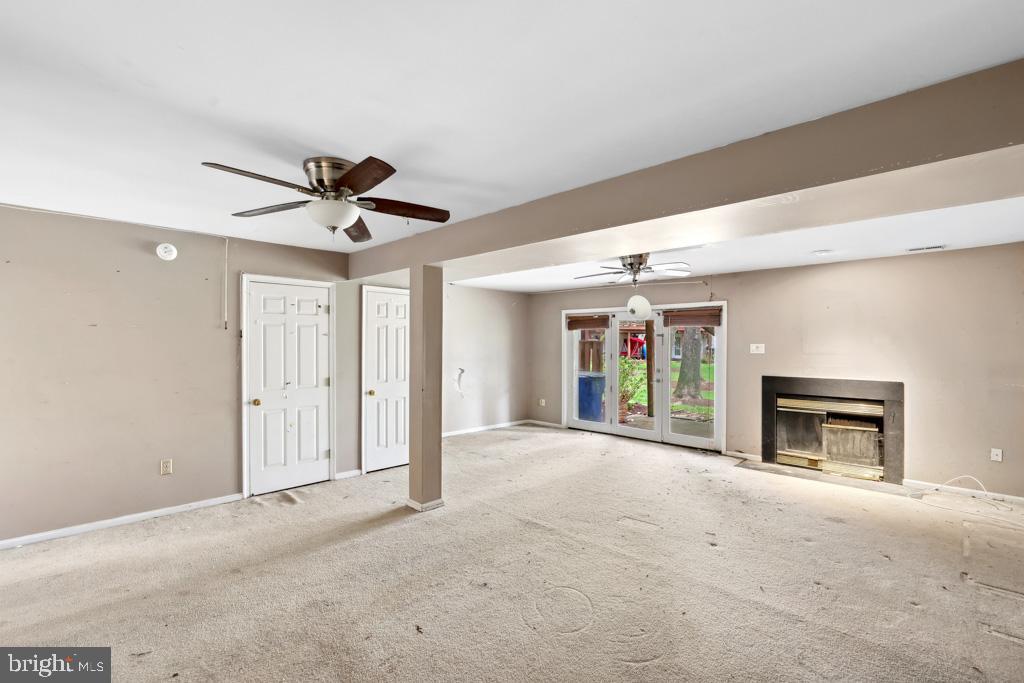 5235 Lightfoot Path Columbia, MD 21044 - Photo 25 of 32 a view of a livingroom with a ceiling fan a fireplace and a large window