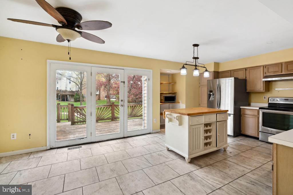 5235 Lightfoot Path Columbia, MD 21044 - Photo 5 of 32 a kitchen with stainless steel appliances granite countertop a refrigerator and a stove top oven