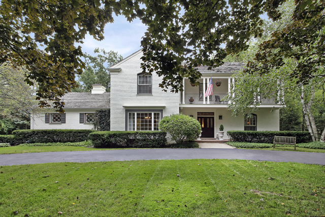 485 Rockefeller Road Lake Forest, IL 60045 - Photo 1 of 21 a front view of a house with a yard and trees