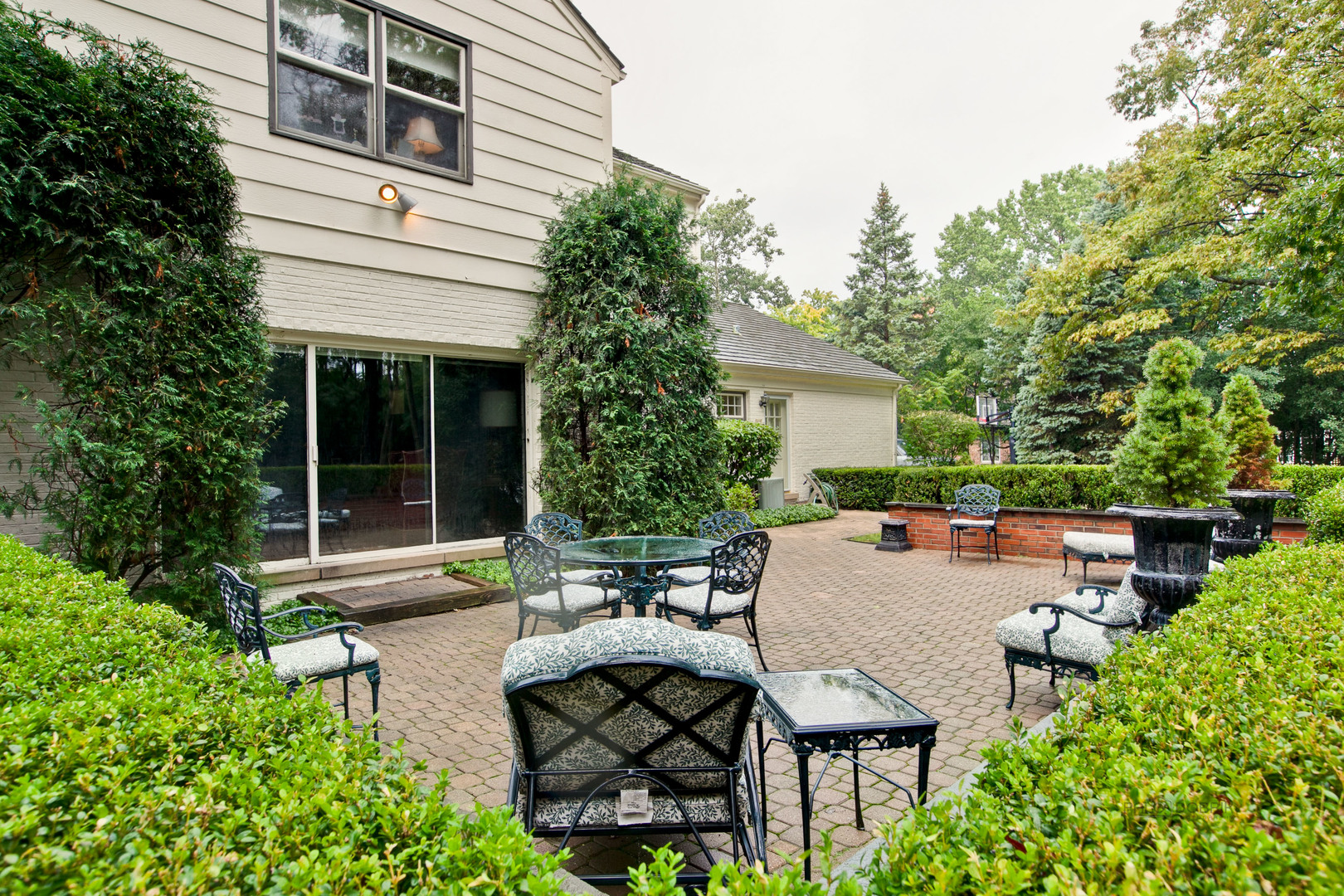 485 Rockefeller Road Lake Forest, IL 60045 - Photo 19 of 21 a view of a patio with table and chairs and potted plants