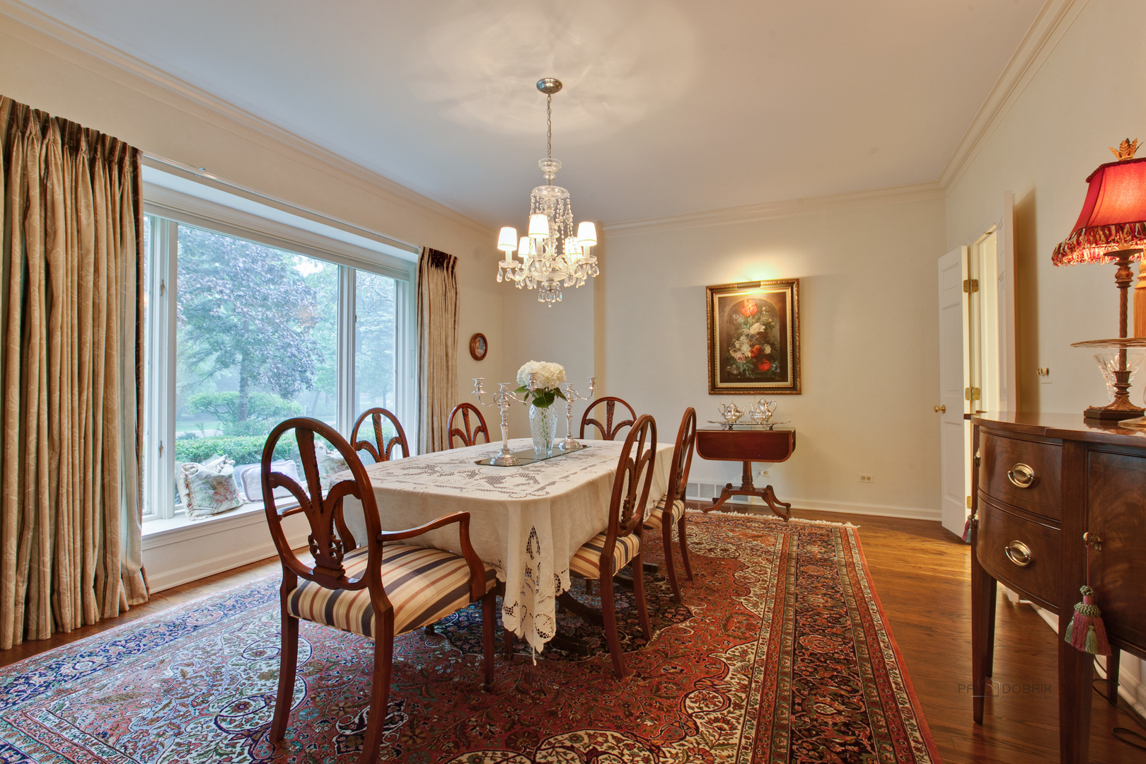 485 Rockefeller Road Lake Forest, IL 60045 - Photo 6 of 21 a dining room with furniture a window and a chandelier