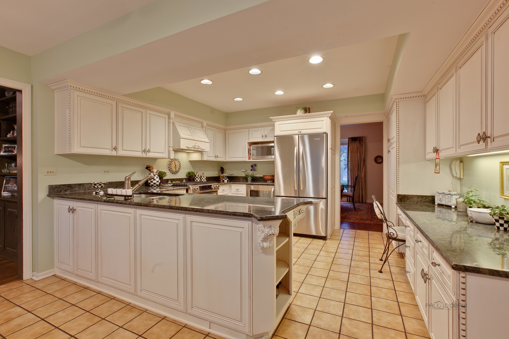 485 Rockefeller Road Lake Forest, IL 60045 - Photo 9 of 21 a kitchen with stainless steel appliances granite countertop a sink stove and refrigerator